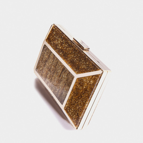 YLIANA YEPEZ minaudire Gold rectangular clutch bag on a light gray background