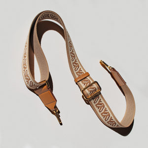 YY Decorative bag strap with camel and beige pattern on a off white background