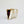 YLIANA YEPEZ Minaudiere. Rectangular clutch with gold frame and beige interior on a white background