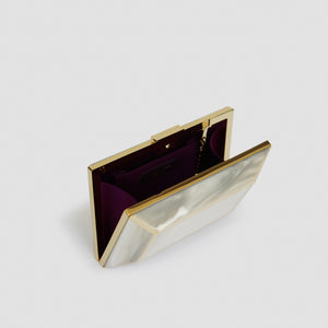 YLIANA YEPEZ Minaudiere. Rectangular clutch with gold frame and beige interior on a white background