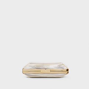 YLIANA YEPEZ Minaudiere. Rectangular clutch with gold frame and beige interior on a white background