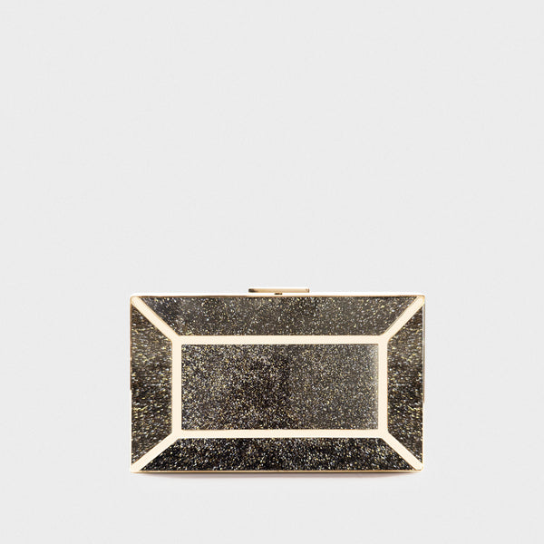 YLIANA YEPEZ minaudire Black glittery clutch bag with gold accents on a light gray background